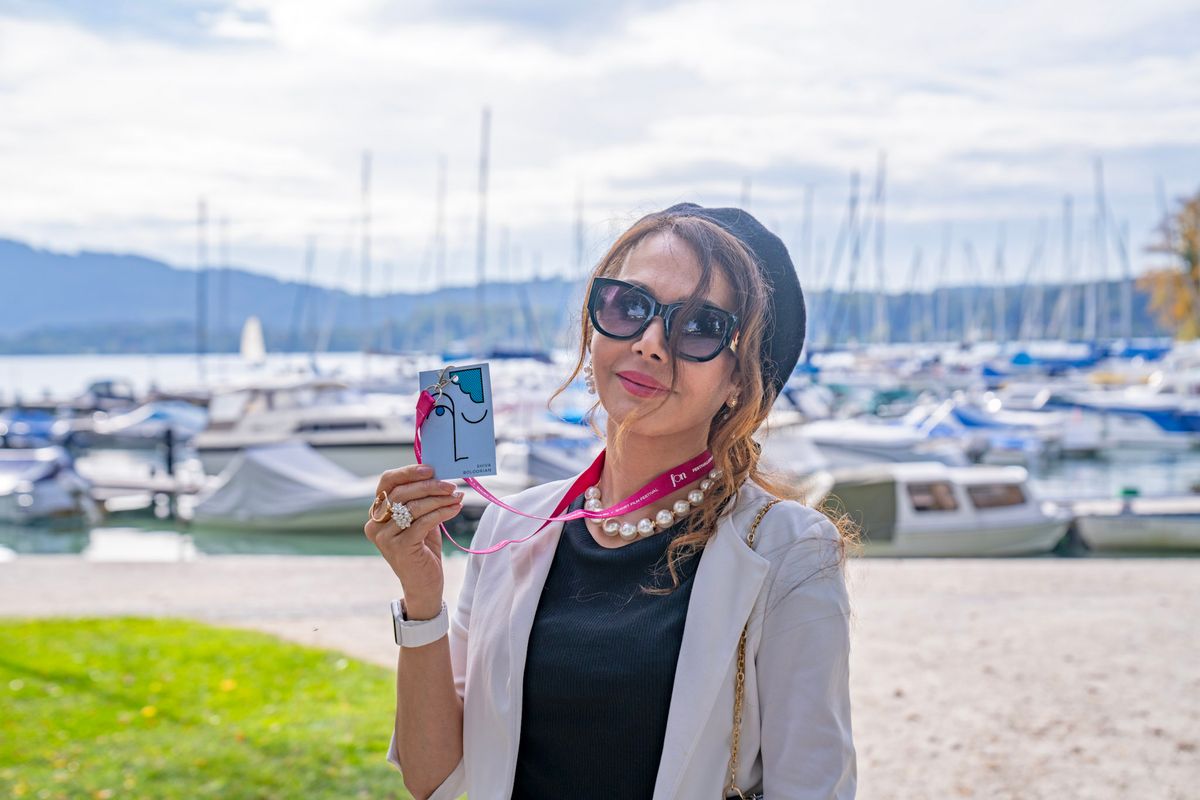Shiva Boloorian with her festival pass by a lake harbour
